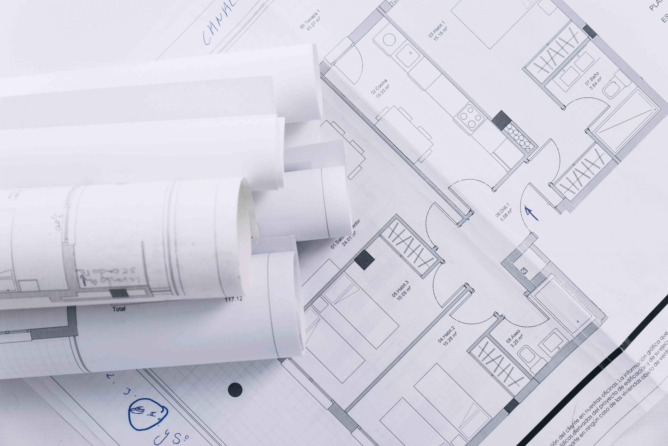 Rolled architectural floor plan blueprints showing detailed room layout – ADS Marketing floor plan service