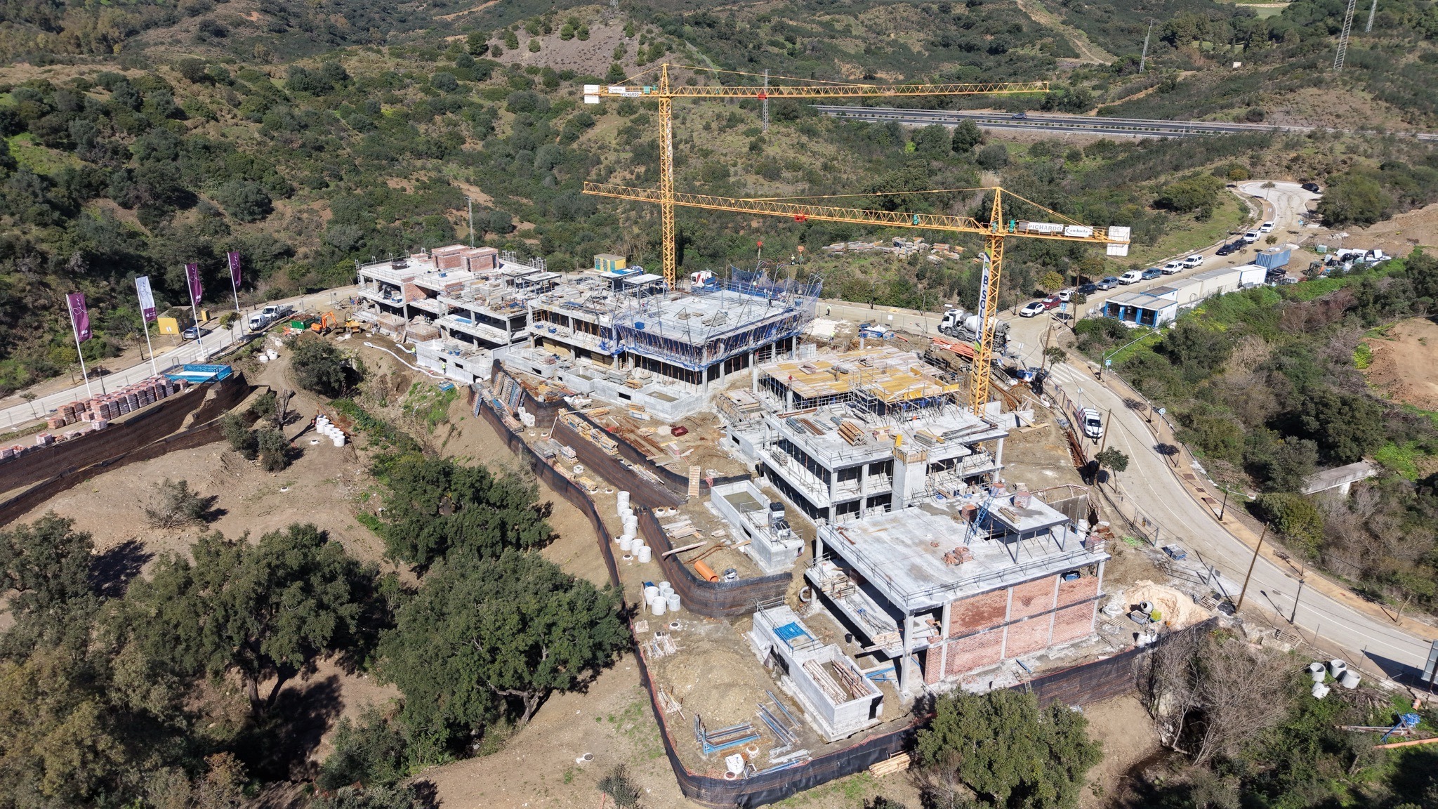 Modern luxury villa at twilight with floor-to-ceiling windows, pool reflections, and mountain views in Marbella