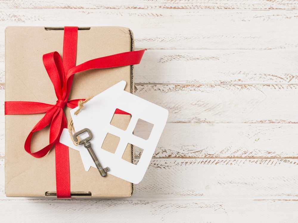 Gift box with a house key and ribbon